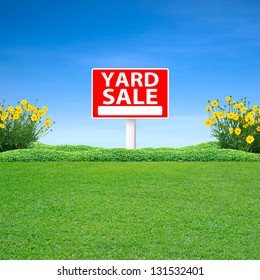 Yard sale sign and green grass