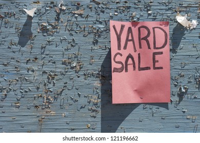 Yard sale sign posted on weathered community board (empty space for your text)