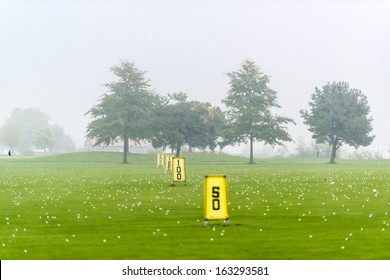 Yard Signs In Driving Range And Golf Balls