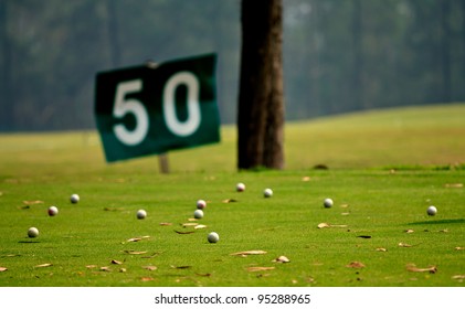 Yard Signs In Driving Range And Golf Ball