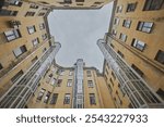 Yard well in St. Petersburg. View of the gray sky, old walls form a window. The city view evokes sad thoughts and loneliness