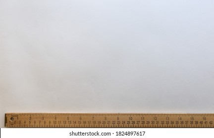 Yardstick placed on the bottom of the image with white space on top for something to be measured in inches or centimeters. Inches scale from 0 to 16 and centimeters scale from 0 to 42.