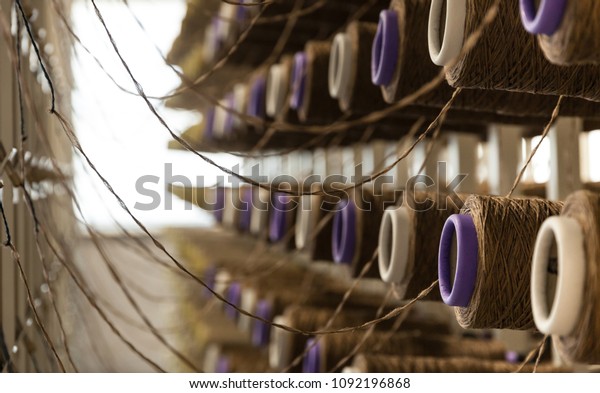 Yarn bobbins\
attached to a carpet weaving\
machine