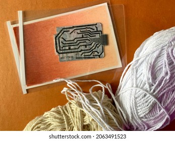 Yarn And Computer Parts On Orange Background