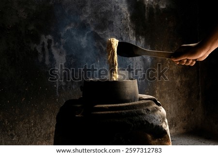 Yarn dyeing process by boiling method. The yarn is dyed with natural dye sources. The yellow dyed yarn is boiled in a hot kettle.