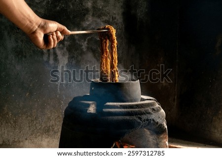 Yarn dyeing process by boiling method. The yarn is dyed with natural dye sources. The yellow dyed yarn is boiled in a hot kettle.