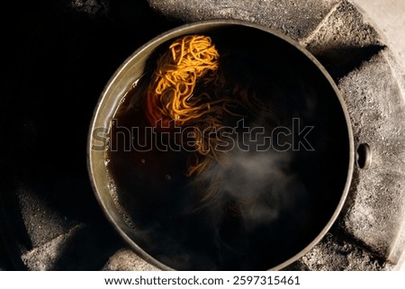 Yarn dyeing process by boiling method. The yarn is dyed with natural dye sources. The yellow dyed yarn is boiled in a hot kettle.