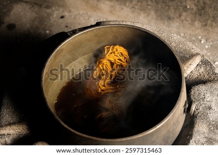 Yarn dyeing process by boiling method. The yarn is dyed with natural dye sources. The yellow dyed yarn is boiled in a hot kettle.