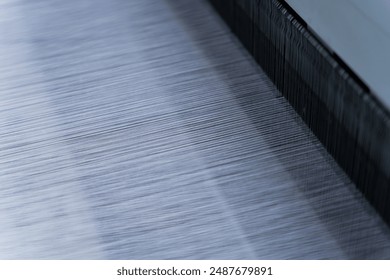 yarn making in air jet loom close up - Powered by Shutterstock