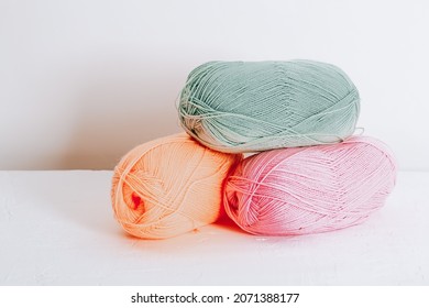 Yarn in pastel spring colors for children's clothing. Balls of wool from delicate pastel threads.