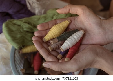 Yarn thread in hand.Hand-woven cotton is a folk wisdom.The device consists of Weaving shuttle, Hand loom ,weaver.Delicate pattern This is a cultural heritage of Thailand.   