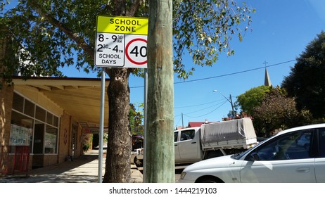 Yass, New South Wales / Australia - March 26 2016: Street Scene Showing School Zone Sign And Parked Cars