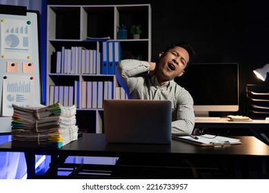 Yawn, burnout and tired businessman is sleepy in the office from deadlines, overworked and overwhelmed with fatigue. Mental health, yawning and exhausted black man working overtime on his computer. - Shutterstock ID 2216733957