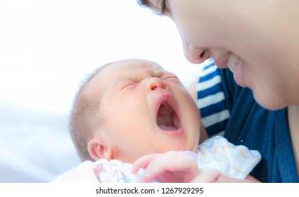 Yawning Innocent Baby,Asian Cute Baby Girl Hugging Her Mother Yawning,Portrait Of A Loving Mother Holding Baby And Talking To Sleep,Newborn Baby Girl Yawning Portrait,Body Language Is Natural,