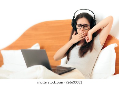 Yawning Sleepy Woman With Headphones And Laptop  - Tired Girl Binge Watching Videos On The Internet Ready To Go To Sleep
