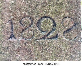 The year 1828 carved in stone and painted in black – taken from an inscription produced that year. Slightly covered with lichen
