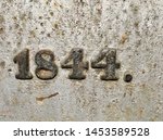 The year 1844 from a cast-iron inscription produced that year, painted in black on a grey background