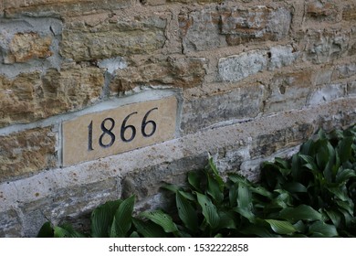 The year 1866 stamped into the side of a stone building to signify when it was built