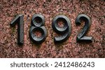 Year 1892 as a symbol on a stone slab
