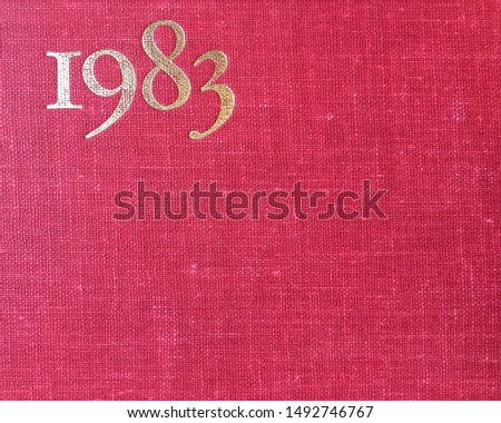 The year 1983 as printed in gold on the red cloth binding of a yearbook published that year