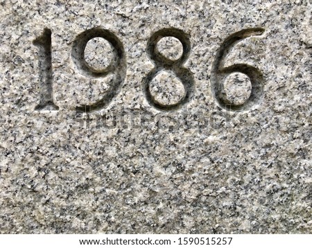 The year 1986 carved into granite – a detail of an inscription produced that year