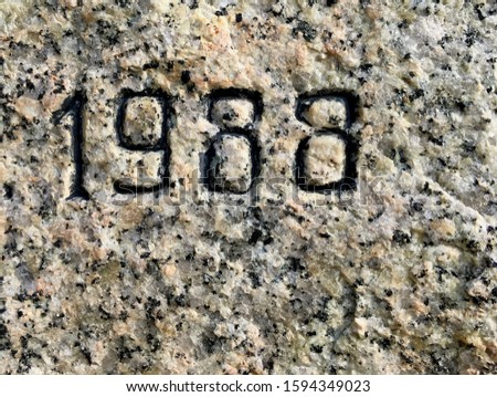 The year 1988 carved into granite and painted in black – a detail of an inscription produced that year