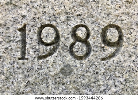 The year 1989 carved into granite – a detail of an inscription produced that year