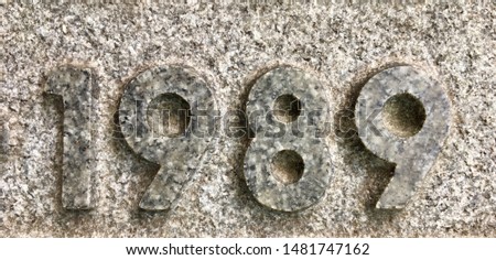 The year 1989 chiselled out of granite and polished – a detail of an inscription produced that year