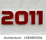 The year 2011, painted in red, indicating the date when the building was erected