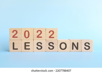 Year 2022 life lessons and learnings concept. Wooden blocks in blue background. - Shutterstock ID 2207788407