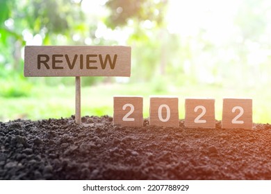 Year end 2022 review and summary concept. Wooden blocks in dark sunset on natural background.	 - Shutterstock ID 2207788929