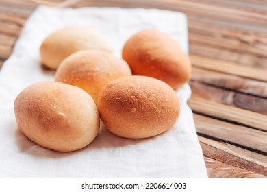 Yeast buns for dinner. Fresh homemade buns on a white linen napkin.	