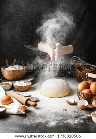 Yeast dough on the table with ingredients for cooking bread or pasta. Table with products for cooking