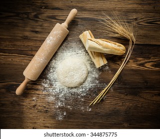 Yeast Dough On Table With Rolling Pin And Baguette, Shot From Above