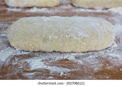 Yeast Puff Pastry. Photo From Above. Photo Of Dough On A Wooden Board With Flour. Whole Grain Flour Dough.