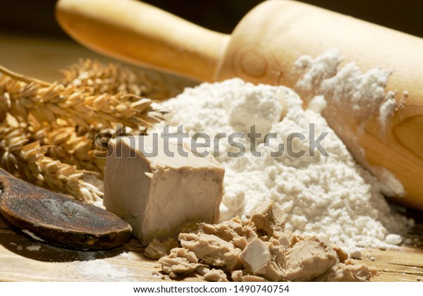 yeast with
wheat flour, wheat ears and rolling
pin