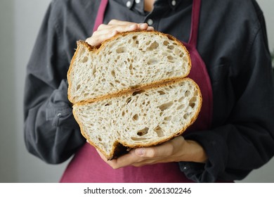 Yeast-free Sourdough Bread. A Beautiful European Woman Baker Holds Bread In Her Hands. Bake Bread For Lunch Or For Sale. A Recipe For Healthy And Delicious Bread For The Whole Family. Bakery Or