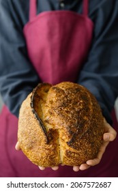 Yeast-free Sourdough Bread. A Beautiful European Woman Baker Holds Bread In Her Hands. Bake Bread For Lunch Or For Sale. A Recipe For Healthy And Delicious Bread For The Whole Family. Bakery Or