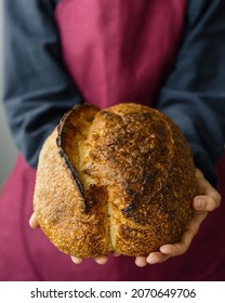 Yeast-free Sourdough Bread. A Beautiful European Woman Baker Holds Bread In Her Hands. Bake Bread For Lunch Or For Sale. A Recipe For Healthy And Delicious Bread For The Whole Family. Bakery Or