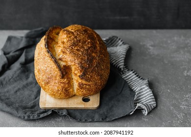 Yeast-free Sourdough Bread. A Beautiful European Woman Baker Holds Bread In Her Hands. Bake Bread For Lunch Or For Sale. A Recipe For Healthy And Delicious Bread For The Whole Family. Bakery Or