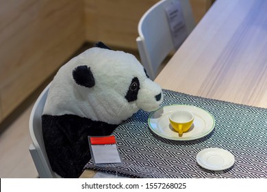 Yekaterinburg, Russia - 15.10.2019: Toy Panda Sits At A Table With A Mug In The IKEA Store. 