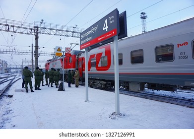 Yekaterinburg, Russia - December 23, 2018 - Russian Soldier Are Smoking On The Platform With The Rossiya Train No.01 From Vladivostok To Moscow At Yekaterinburg Railway Station In Winter