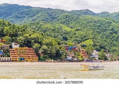 Yelapa, Mexico - September 17, 2021 - water taxi boats and houses in the remote jungle beach town of Yelapa, Jalisco - only accessible by boat