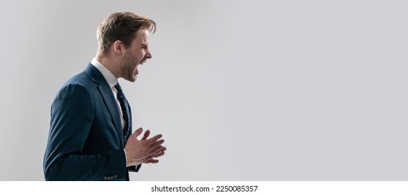 Yelling and screaming. Man face portrait, banner with copy space. Business man in suit, isolated studio background, banner poster. Angry businessman scream grey background. - Powered by Shutterstock