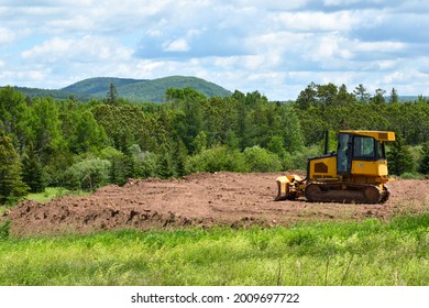Yelllow Bulldozer Clearing Land in the Countryside in Summer - Shutterstock ID 2009697722