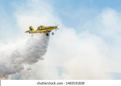 Yellow Aerial Firefighting Aircraft Drop Water With Foam On Fire