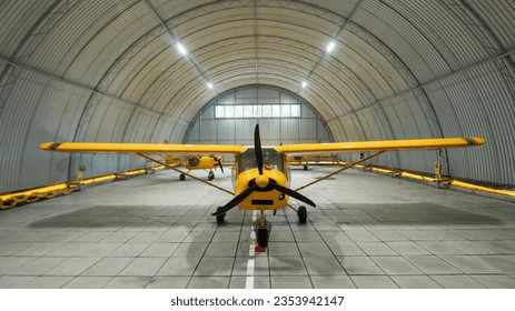 Yellow airplane glider in the hangar. 
