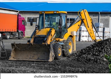 The Yellow All-wheel Drive Backhoe Loader Stands On The Yard Ready For Workind On Construction Site.