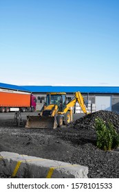 The Yellow All-wheel Drive Backhoe Loader Stands On The Yard Ready For Workind On Construction Site.