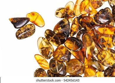 Yellow amber stones on a white background.